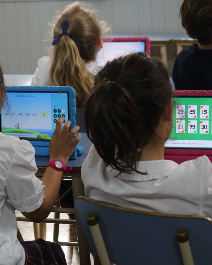 Alumnas de primaria resolviendo ejercicios en tablets